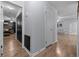 Hallway leading to the living areas with wood floors, neutral paint, and a closet at 660 Silver Pass, Ocala, FL 34472