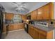 Kitchen boasts wood cabinets, tiled backsplash and modern appliances at 660 Silver Pass, Ocala, FL 34472