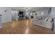 Bright living room with hardwood floors, a sectional sofa, and sliding doors leading to an outdoor space at 660 Silver Pass, Ocala, FL 34472