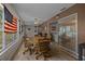 Large living room with a wood table, comfortable chairs, hardwood floors, and flags at 660 Silver Pass, Ocala, FL 34472