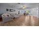 Open living space with hardwood floors, a sectional sofa, and access to the dining area and front entrance at 660 Silver Pass, Ocala, FL 34472