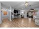 Inviting living area with hardwood floors, a ceiling fan, a built-in entertainment center, and a sliding glass door at 660 Silver Pass, Ocala, FL 34472