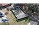 Aerial shot of a covered tennis court and nearby playground at 660 Silver Pass, Ocala, FL 34472