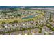 Expansive aerial shot of a residential community featuring a scenic lake and lush green spaces at 7455 Sw 97Th Terrace Rd, Ocala, FL 34481