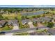 This aerial view highlights the home's prime location near a lake and golf course, surrounded by mature trees at 7455 Sw 97Th Terrace Rd, Ocala, FL 34481