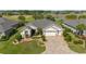 Aerial shot overlooking the property, showcasing its lush landscaping, proximity to a serene lake, and well-kept golf course at 7455 Sw 97Th Terrace Rd, Ocala, FL 34481