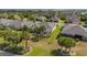 Lush backyard featuring a screened lanai, mature trees, and meticulous landscaping at 7455 Sw 97Th Terrace Rd, Ocala, FL 34481