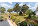 Landscaped backyard with green grass, trees, and a view of the community golf course at 7455 Sw 97Th Terrace Rd, Ocala, FL 34481
