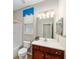 Bathroom features a vanity with wood cabinets, modern fixtures and a shower-tub combo at 7455 Sw 97Th Terrace Rd, Ocala, FL 34481