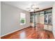 Spare bedroom featuring hardwood floors, built-in shelving, and natural lighting at 7455 Sw 97Th Terrace Rd, Ocala, FL 34481
