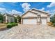 Paver driveway leads to a well-maintained home with a two-car garage at 7455 Sw 97Th Terrace Rd, Ocala, FL 34481