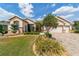 Charming home featuring manicured landscaping, mature trees, and a brick driveway at 7455 Sw 97Th Terrace Rd, Ocala, FL 34481