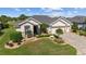Charming home with manicured landscaping, a brick driveway, and a well-maintained lawn creating curb appeal at 7455 Sw 97Th Terrace Rd, Ocala, FL 34481