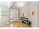 Inviting foyer with tiled floor, neutral walls, transom window and decorative console table at 7455 Sw 97Th Terrace Rd, Ocala, FL 34481
