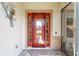 Inviting red front door with glass insert and sidelights at 7455 Sw 97Th Terrace Rd, Ocala, FL 34481