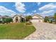 Beautifully landscaped front yard with manicured bushes and brick driveway at 7455 Sw 97Th Terrace Rd, Ocala, FL 34481