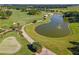 Panoramic aerial view of a well-kept golf course, including a water hazard with a fountain feature at 7455 Sw 97Th Terrace Rd, Ocala, FL 34481