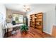 Home office with hardwood floors, built-in bookcase and a large window with neighborhood views at 7455 Sw 97Th Terrace Rd, Ocala, FL 34481
