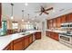 Open kitchen featuring a spacious island, stainless steel appliances, granite countertops, and a breakfast bar at 7455 Sw 97Th Terrace Rd, Ocala, FL 34481