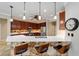 Kitchen featuring stone accent, bar seating, pendant lighting, stainless appliances, and wood cabinetry at 7455 Sw 97Th Terrace Rd, Ocala, FL 34481