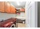 Well-equipped laundry room with cherry cabinets, sink and modern, front-loading machines at 7455 Sw 97Th Terrace Rd, Ocala, FL 34481