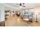 Open living room with breakfast bar, kitchen, dining room, comfortable sofa and view of the backyard at 7455 Sw 97Th Terrace Rd, Ocala, FL 34481