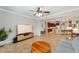 Open-concept living area featuring tile floors, ceiling fan, and seamless access to the kitchen with breakfast bar at 7455 Sw 97Th Terrace Rd, Ocala, FL 34481