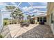 Large, screened-in patio with comfortable seating, dining area, and a view of the golf course at 7455 Sw 97Th Terrace Rd, Ocala, FL 34481
