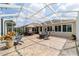 Spacious covered patio featuring outdoor seating, dining area, and beautiful golf course views at 7455 Sw 97Th Terrace Rd, Ocala, FL 34481