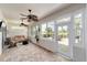 Relaxing sunroom with ceiling fans, brick floors, and sliding glass doors to the outside patio at 7455 Sw 97Th Terrace Rd, Ocala, FL 34481