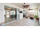 Bright sunroom with tile flooring, ceiling fans, and sliding glass doors for seamless indoor-outdoor living at 7455 Sw 97Th Terrace Rd, Ocala, FL 34481
