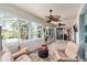 Well-lit sunroom with comfortable seating, chess table, and access to the outdoor patio at 7455 Sw 97Th Terrace Rd, Ocala, FL 34481