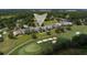 Aerial view of the property showcasing its location on the golf course with mature trees at 7585 Nw 33Rd Pl, Ocala, FL 34482