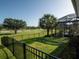 A view of the backyard featuring an iron fence overlooking the golf course at 7585 Nw 33Rd Pl, Ocala, FL 34482