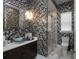 Modern bathroom with mosaic tile walls, a glass-enclosed shower, and a stylish vessel sink at 7585 Nw 33Rd Pl, Ocala, FL 34482