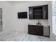 Bonus room featuring hardwood floors, custom cabinets with wet bar, and flat screen television at 7585 Nw 33Rd Pl, Ocala, FL 34482