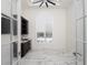 Bonus room featuring hardwood floors, custom cabinets with wet bar, and arched window at 7585 Nw 33Rd Pl, Ocala, FL 34482