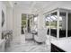 Bright dining area with modern light fixture and sliding glass doors leading to the outdoor patio at 7585 Nw 33Rd Pl, Ocala, FL 34482