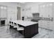 Modern kitchen with white cabinets, a large island, and marble floors at 7585 Nw 33Rd Pl, Ocala, FL 34482