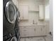 Convenient laundry room with modern appliances, ample counter space, and storage cabinets at 7585 Nw 33Rd Pl, Ocala, FL 34482