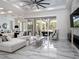 Bright living room with a fireplace, floor-to-ceiling windows, and marble floors at 7585 Nw 33Rd Pl, Ocala, FL 34482