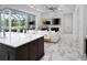 Stylish living room with a marble-topped island, modern decor, and open access to the kitchen at 7585 Nw 33Rd Pl, Ocala, FL 34482