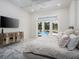 Bright main bedroom featuring hardwood floors and sliding glass doors leading to the pool at 7585 Nw 33Rd Pl, Ocala, FL 34482