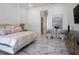 Bright main bedroom featuring hardwood floors, sitting area, and large flat screen television at 7585 Nw 33Rd Pl, Ocala, FL 34482