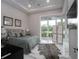 Comfortable bedroom with a large sliding glass door, rug, and a decorative screen at 7585 Nw 33Rd Pl, Ocala, FL 34482
