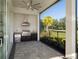 Outdoor kitchen with a stainless steel grill, beverage cooler, and dark cabinets in a screened patio at 7585 Nw 33Rd Pl, Ocala, FL 34482
