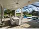 Screened patio with a ceiling fan, outdoor seating, and a view of the pool and golf course at 7585 Nw 33Rd Pl, Ocala, FL 34482