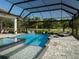 Beautiful pool with spa and lush landscaping offers a private outdoor oasis at 7585 Nw 33Rd Pl, Ocala, FL 34482