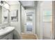 Hall bathroom with sink, medicine cabinet, and updated shower at 8 Banyan Dr, Ocala, FL 34472