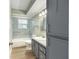 Bright bathroom with a shower-tub combination, a blue tile surround, and a gray vanity at 8 Banyan Dr, Ocala, FL 34472